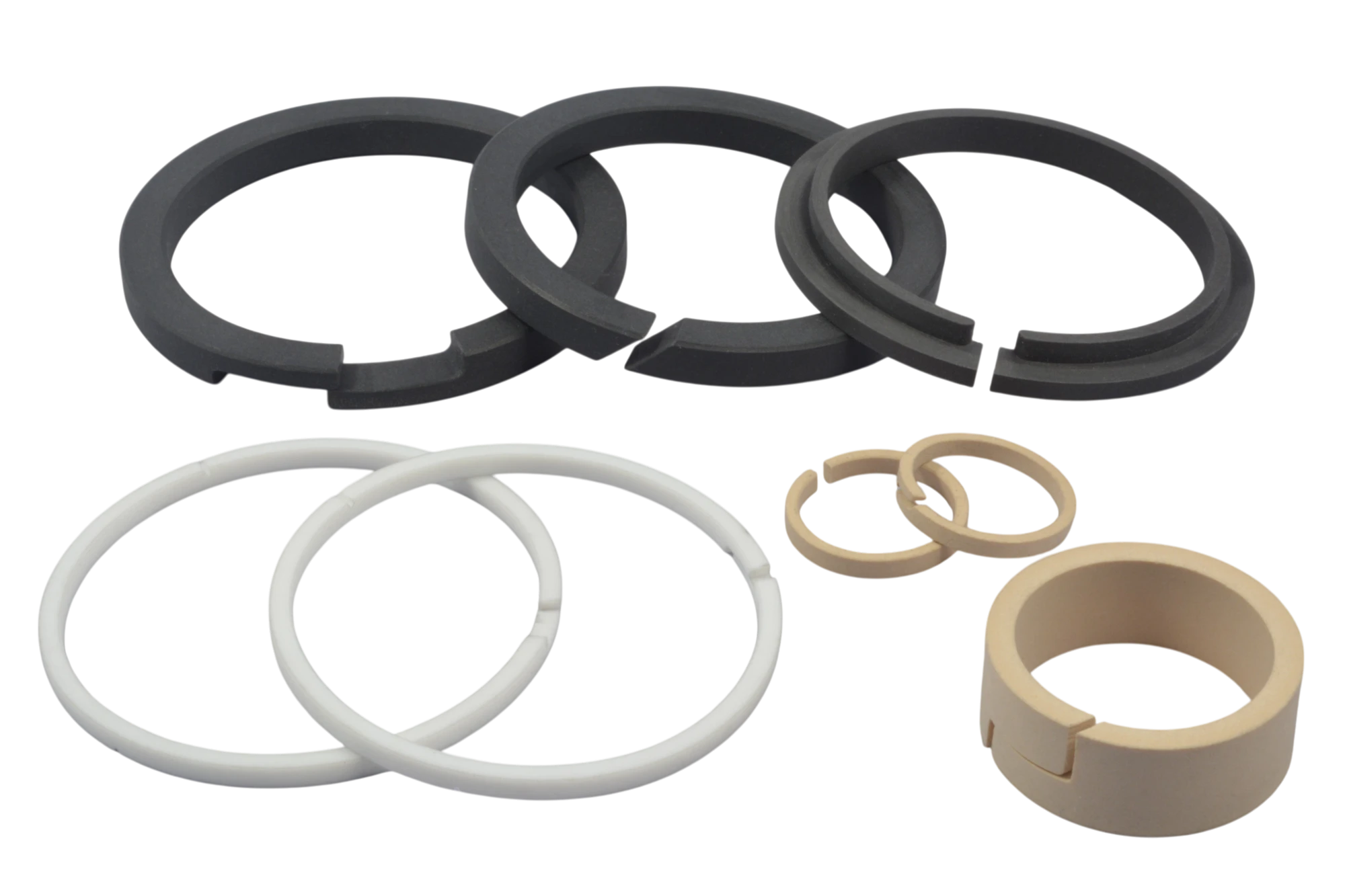 Assorted rubber O-rings and gaskets in black, white, and beige on a black background