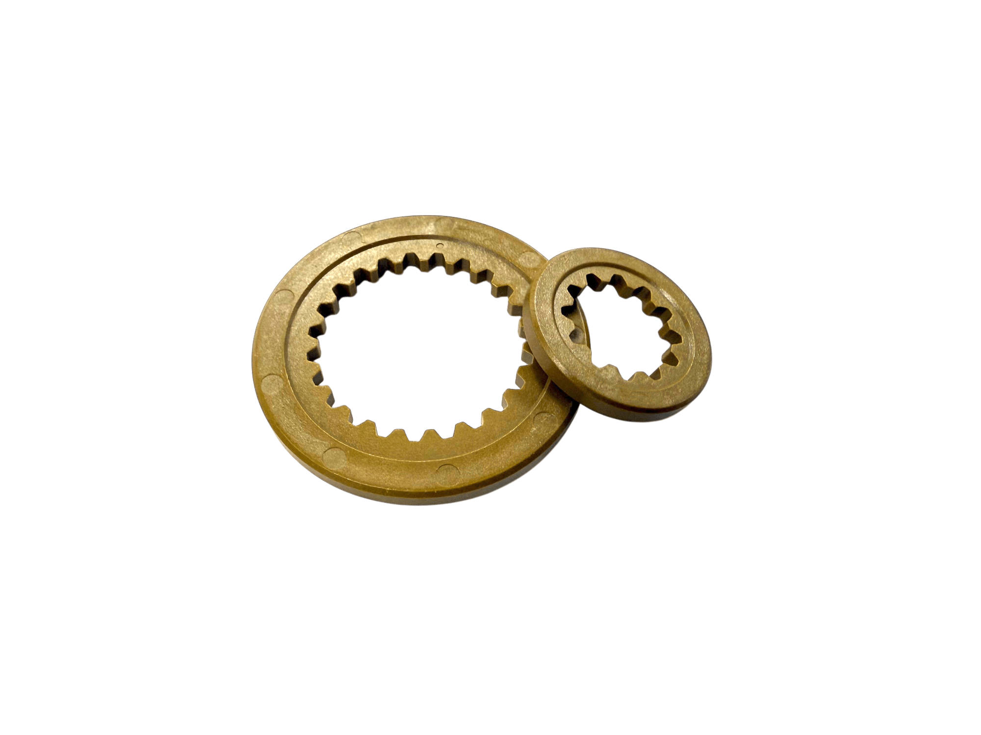 Two gold-colored ring gears with internal teeth resting on a black background, one overlapping the other.